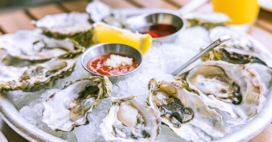 An image showing a platter of fresh premium oysters on ice.